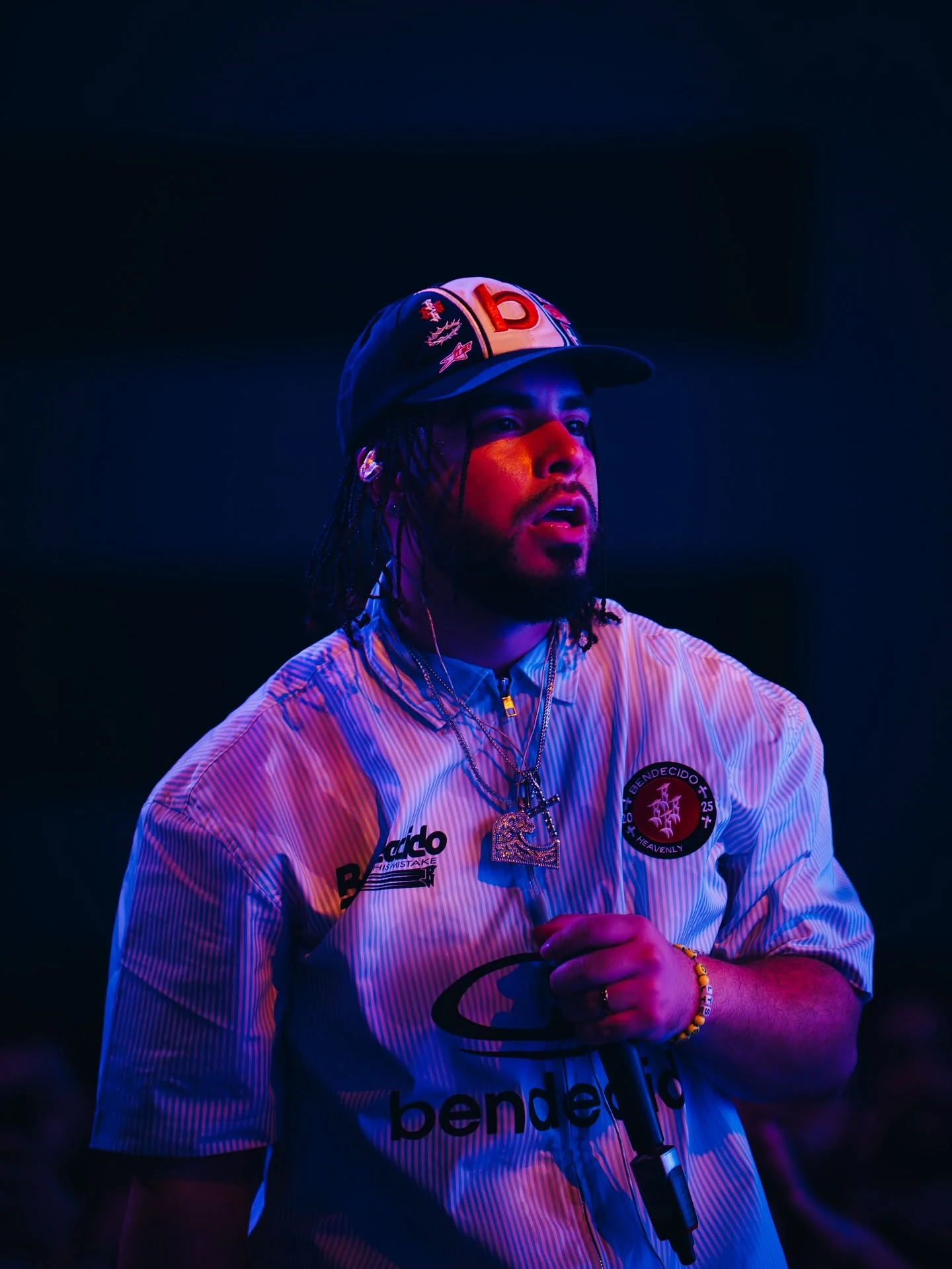 Kenny Rivers performing under red and blue stage lighting